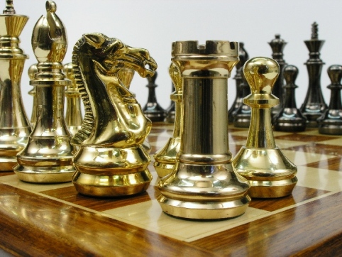 A selection of luxury chess pieces in brass, steel, copper, ebony and black-and-gold finishes suitable for a special gift